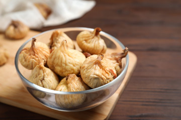 Tasty dried figs on wooden table, closeup