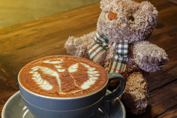 cup of the latte art coffee with warm light