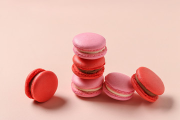 Delicious sweet macaroons on a pink background, red and pink macaroons, Concept for Valentine's Day, March 8 and Mother's Day