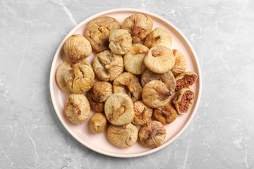 Tasty dried figs on light grey marble table, top view