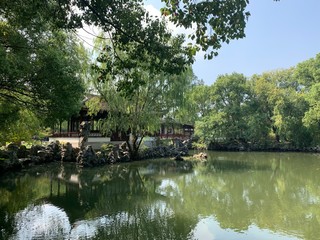 Fototapeta na wymiar Scenes of a traditional Chinese park with waterways and raised walkways.