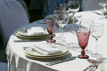 Served for banquet restaurant table with dishes, snack, cutlery, wine and water glasses, european food, selective focus