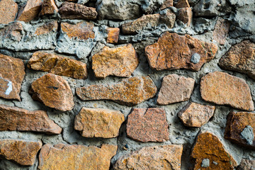 The texture of the old masonry. Background image of a stone-lined wall