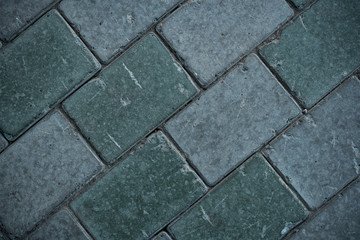 Texture of paving slabs overgrown with grass. Background image of a stratum stone