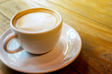 cup of the latte art coffee with warm light