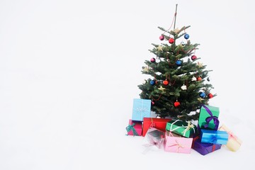 Christmas tree with presents in snow