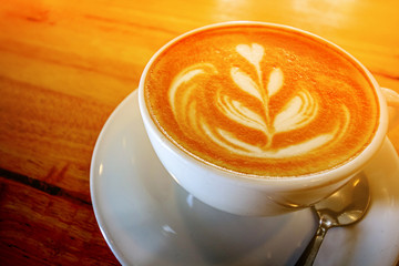 cup of the latte art coffee with warm light