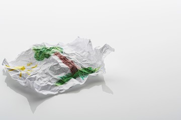 Crumpled sheet of paper with drawing of tree and sun