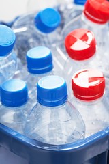 Empty plastic bottles in container close-up