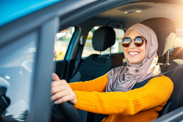 Relaxed Muslim woman on summer roadtrip travel vacation. Confident and beautiful. Portrait of pleasant looking female with glad positive expression, being satisfied with unforgettable journey by car