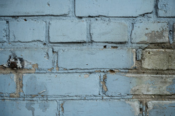 Texture of an old paint covered brick wall. Background image of an abandoned brick wall with painted over paint