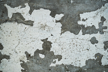 Texture of an old cracked concrete wall. Background image of a worn gray concrete surface
