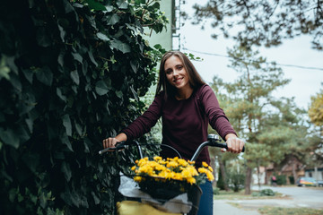 woman with flowers riding bike outdoors