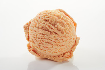 Scoop of orange ice cream in a close up texture