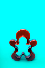 Plastic form for cutting a gingerbread man standing on a blue emerald background. Christmas minimal...