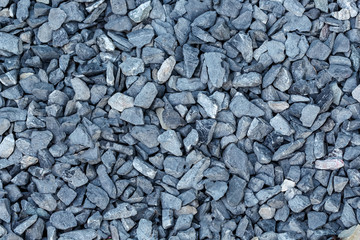 Black small road stone background, dark gravel pebbles stone texture seamless texture,...