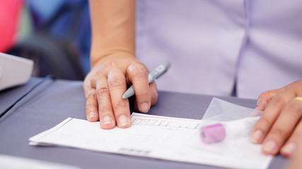 doctor injecting with syringe to patient's arm drawing blood sample for blood test in hospital. 24 Nov 2019 Bangkok Thailand.    