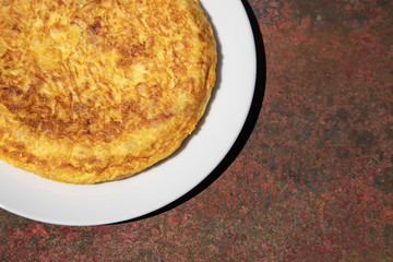 Spanish home made tortilla de patatas spanish potato omelette tapa tapas delicious food on a rusty table