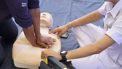 Rescuers teaches how to pump a heart, silicone rubber dummy.                                     