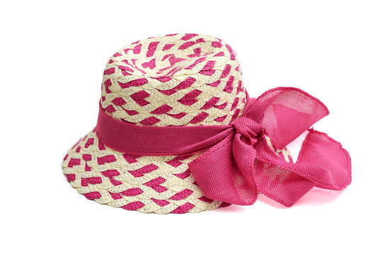 Wicker female hat with a pink ribbon isolated on white background