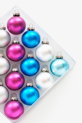 Christmas baubles in tray on white background