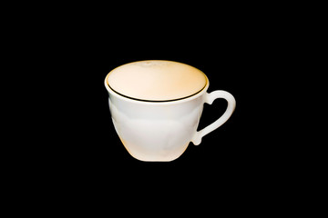 black coffee pour into a white mug on a dark background