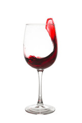 Red wine is splashing out of a wine glass