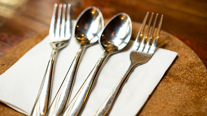 Spoons and forks are lined up.