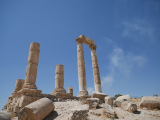 Fototapeta na wymiar Tall majestic pillars of the ruins of the Roman site of Amman Citadel on a hill in the city center of the capitol of Jordan