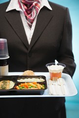 Stewardess Holding Tray With Airplane Food