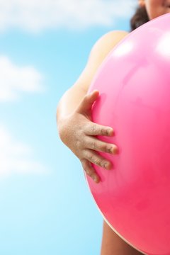 Girl Holding Pink Beach Ball