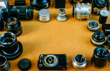 Fototapeta na wymiar Retro mockup, vintage photographic accessories and quipments around on wooden Background. Top view