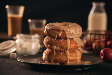 Close-up of donuts in stack with milk bottle and glass