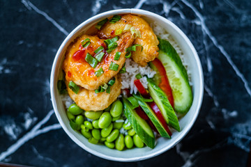 Take Away Healthy Buddha Bowl with Shrimp, Edamame Beans, Cucumber and Basmati Rice / Poke Bowl in Plastic Box Package or Container.