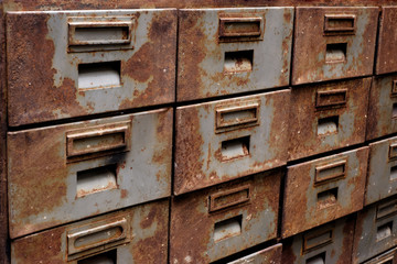 Old rusty metal closet with pullout drawers