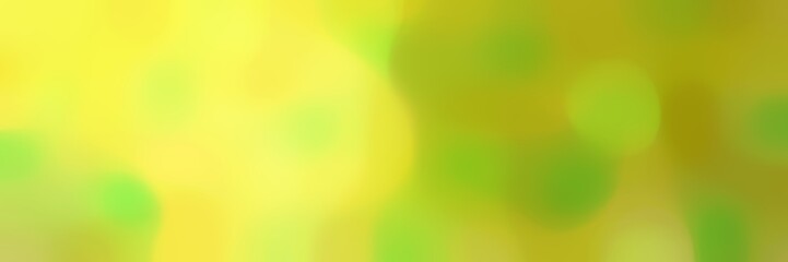 blurred horizontal background with yellow green, pastel orange and khaki colors and space for text