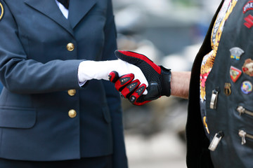 Handshake. Female hand in gloves and male.