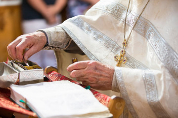 Orthodox religion. Hands of the priest on the bible.