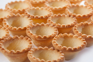 A large number of empty forms of yeast-free dough for subsequent filling. The view from the top. Out of focus.