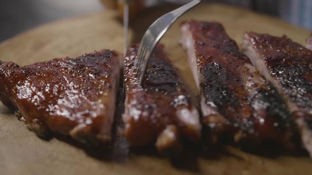Close-up of cutting BBQ ribs steak 