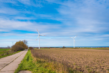 Windmills for electric power production surrounded by field in typical Polish countryside. Poland. Europe.