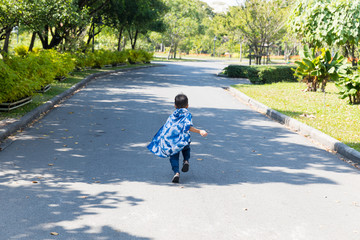 A child wearing a veil Running at the park