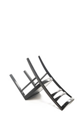 Inverted black wooden stool isolated on white