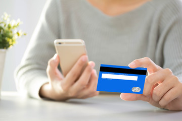 Woman paying using a credit card  Focus on woman hands holding credit card concept online shopping and payment