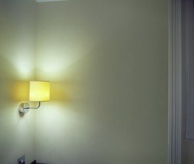 Sconce Shining Light On Wall In Room