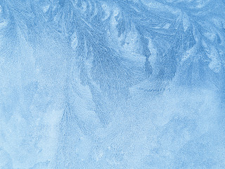 ice texture on a transparent glass surface.  frozen background.  winter pattern on the window.