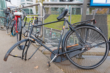 Fototapeta na wymiar abandoned and broken bike with front wheel stolen; damaged, vandalised