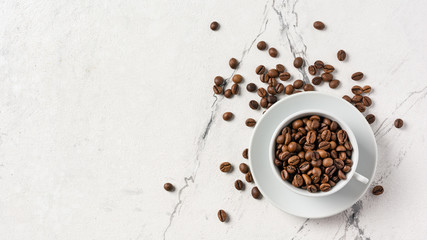Roasted coffee beans in white cup