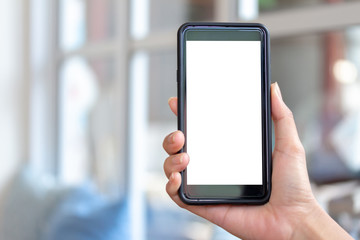 mockup a cellphone in a restaurant with a blank white screen. Woman holding a black mobile