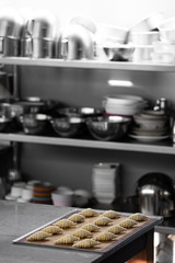 Raw croissants preparation for with raw egg painted on top process before baking with shelf of utensils in the background /baking concept / copy space